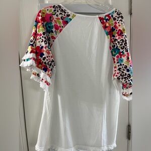 White shirt. With fun design on sleeves.  Never worn. Smoke free home.